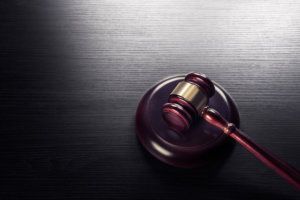 Judge gavel on a black wooden background