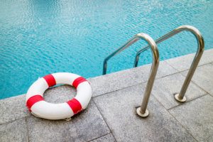 Life ring at edge of swimming pool.