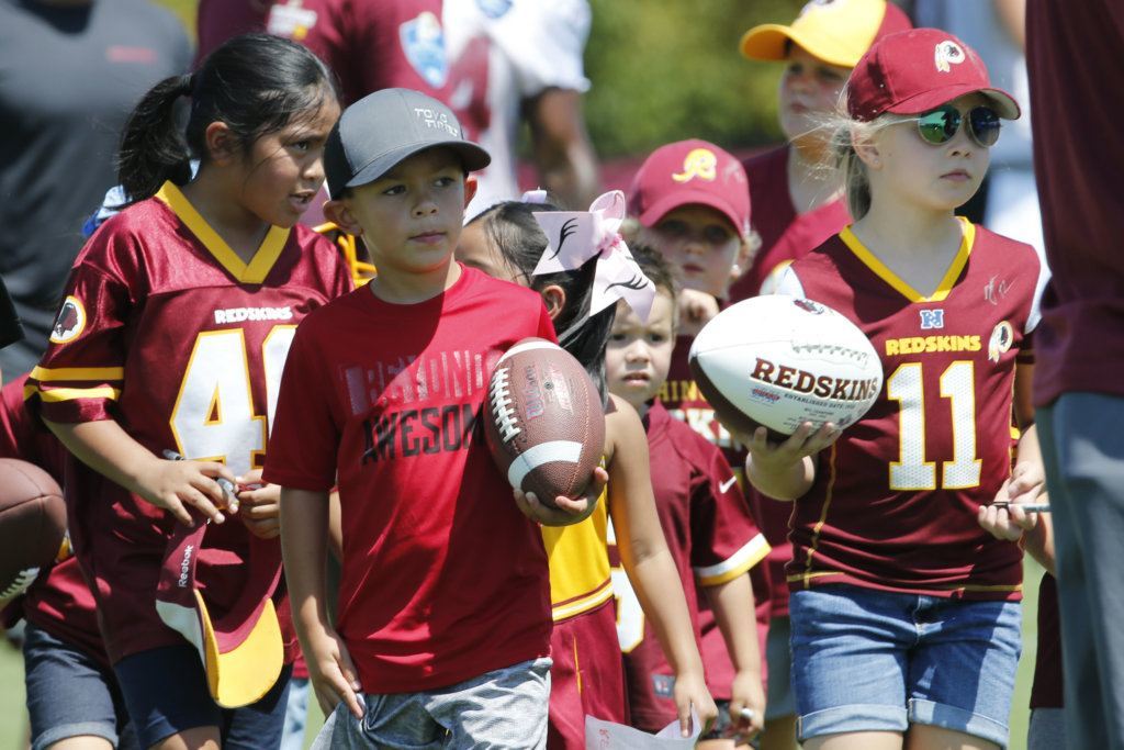 Washington Redskins fans seek out players for autographs during the first day of NFL football training camp in Richmond, Va., Thursday, July 25, 2019.