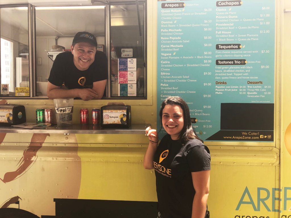 Arepa Zone owners <span style="font-weight: 400;">Gabriela Febres and Ali Arellano outside their food truck. </span>