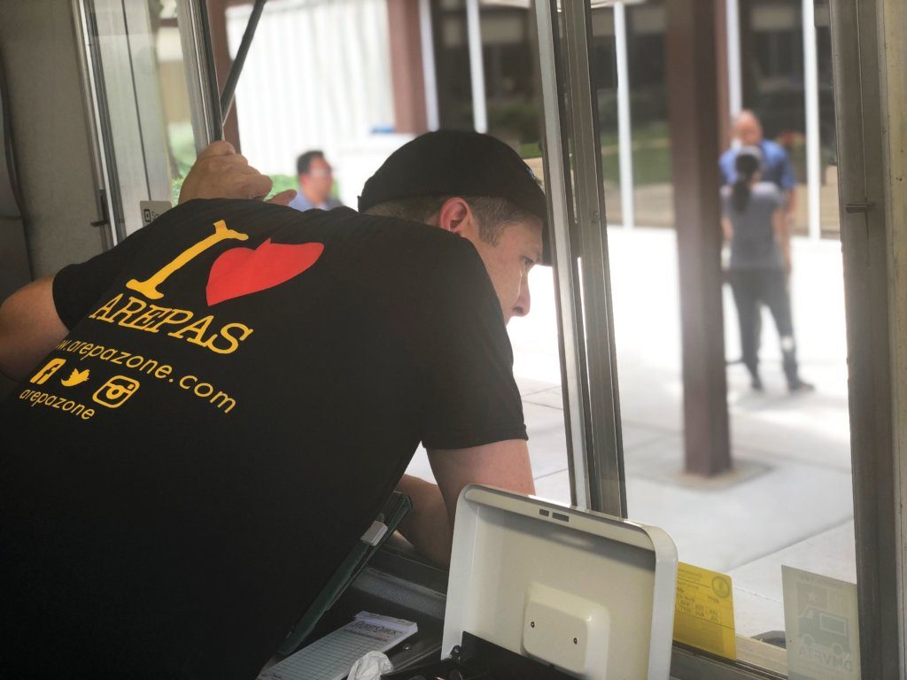 Arepa Zone co-owner <span style="font-weight: 400;">Ali Arellano talks to a customer from the truck window in Northwest D.C. </span>