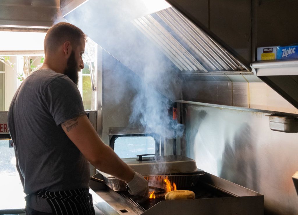 <span style="font-weight: 400;">Rosen Ivanov cooks on his food truck, Balkanik Taste, in Montgomery County, Maryland. </span>