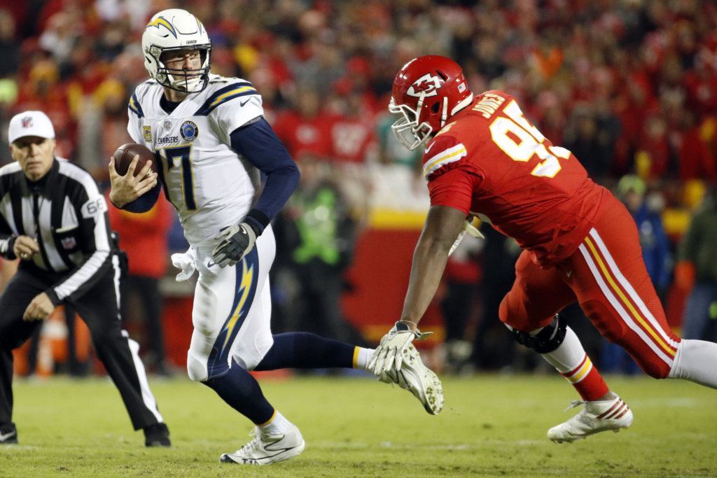 File-This Dec. 13, 2018, file photo shows Los Angeles Chargers quarterback Philip Rivers (17) running away from Kansas City Chiefs defensive end Chris Jones (95) before being sacked, during the first half of an NFL football game in Kansas City, Mo. Jones has become a sacks machine, force against the run, and one of the few Chiefs earning his keep all season on defense. He’s not quite at the Aaron Donald level, but he’s getting closer.