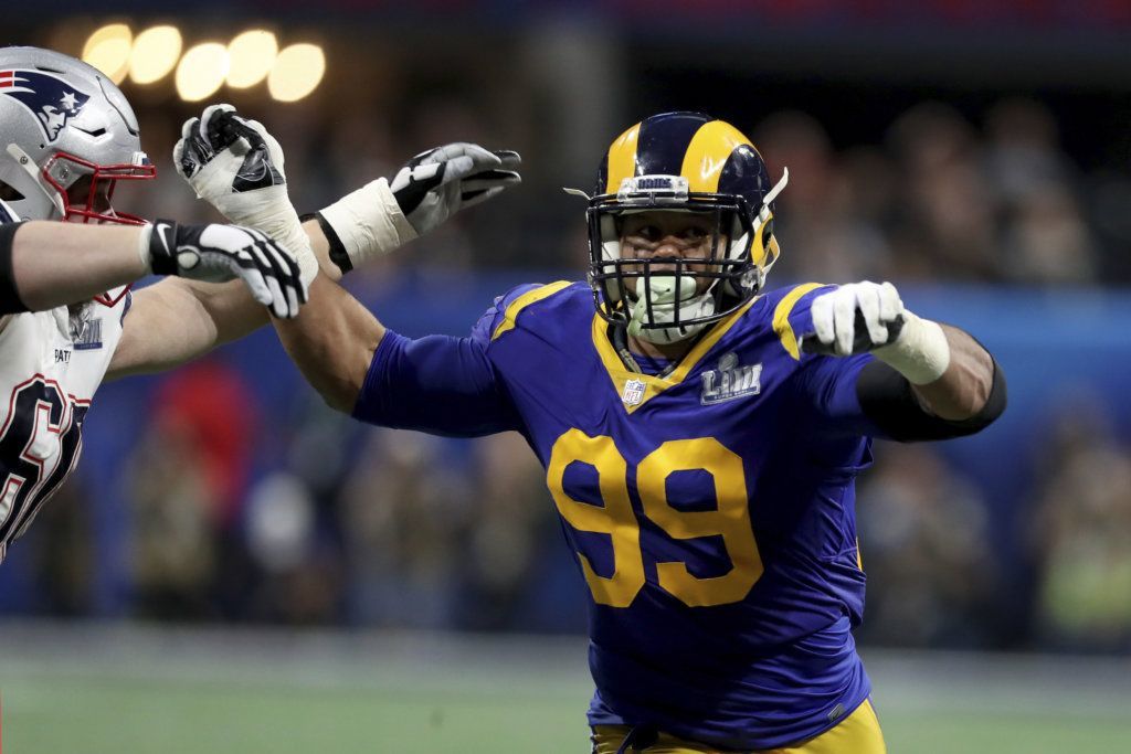 FILE - In this Feb. 3, 2019, file photo, Los Angeles Rams Aaron Donald (99) rushes against the New England Patriots during NFL Super Bowl 53 in Atlanta. Donald is participating in his first training camp since 2016 after holding out for the past two summers in search of a new contract.