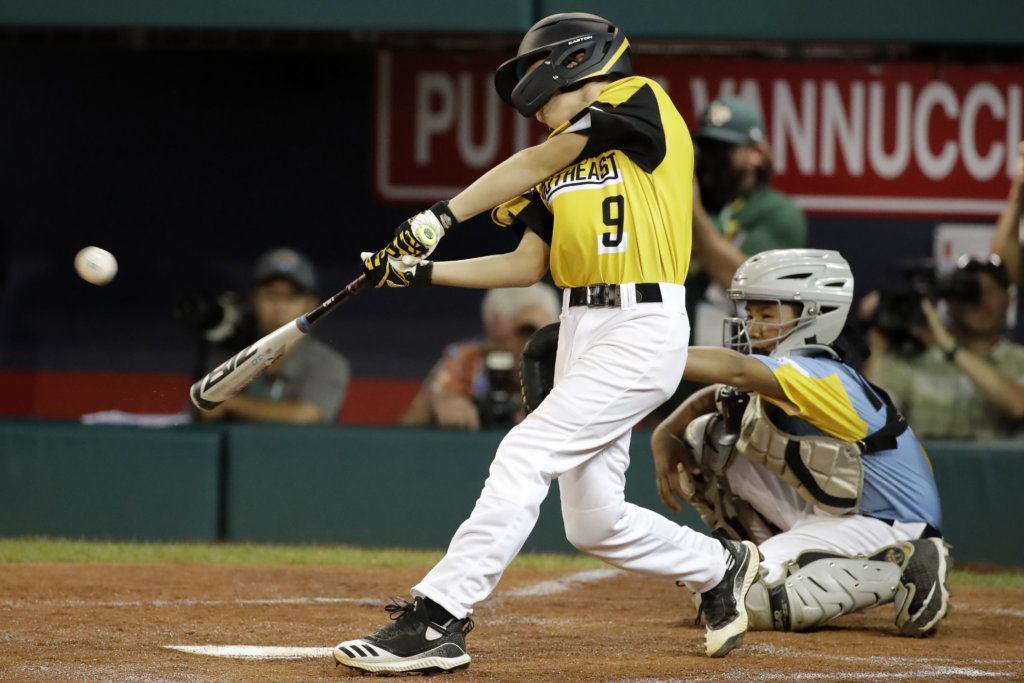 South Riding, Virginia's Colton Hicks (9) drives in a run with a triple off Wailuku, Hawaii's Kaedyn Miyake-Matsubayashi (6) during the first inning of an baseball game at the Little League World Series tournament in South Williamsport, Pa., Wednesday, Aug. 21, 2019.