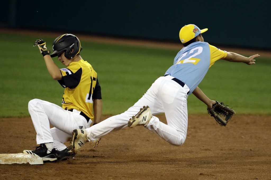 Wailuku, Hawaii's Bransyn Hong (22) throws to first after getting the force out on South Riding, Va.'s Brady Yates during the first inning of a baseball game at the Little League World Series in South Williamsport, Pa., Wednesday, Aug. 21, 2019. Virginia's Justin Lee was safe at first.