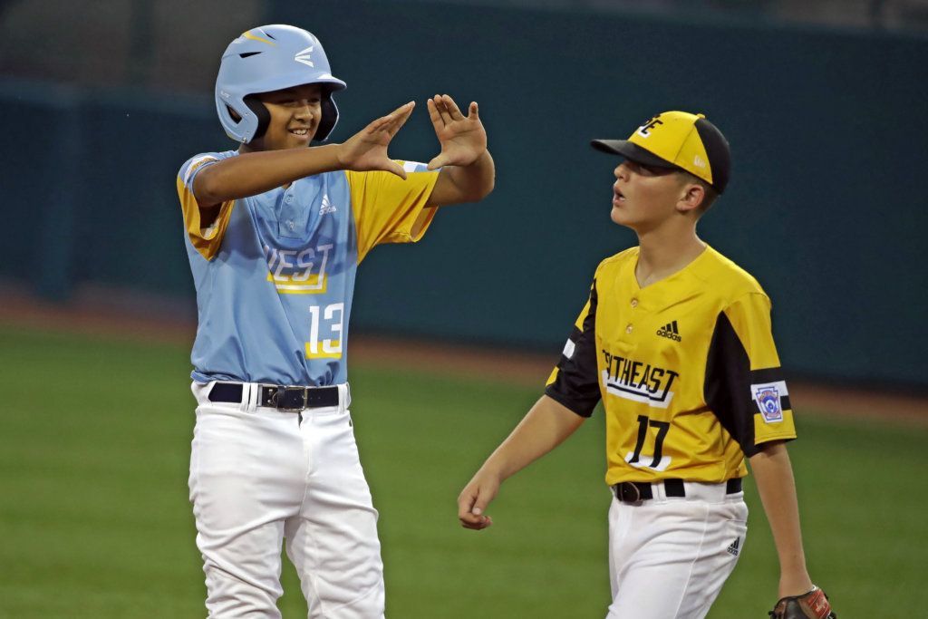 Wailuku, Hawaii's Shiloh Gilliland (13) celebrates on second base near South Riding, Va.'s Chase Obstgarten (17) after driving in two runs with a double off pitcher Liam Thyen during the first inning of a baseball game at the Little League World Series in South Williamsport, Pa., Wednesday, Aug. 21, 2019.