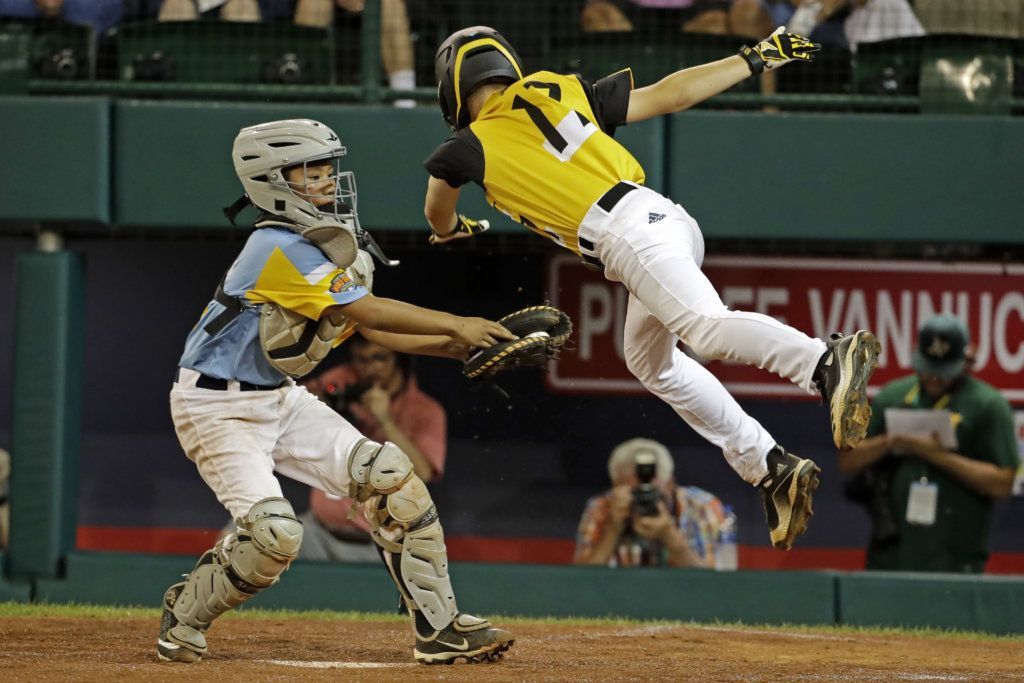 South Riding, Virginia's Chase Obstgarten (17) is tagged out attempting to steal home by Wailuku, Hawaii's Duke Aloy during the third inning of an baseball game at the Little League World Series tournament in South Williamsport, Pa., Wednesday, Aug. 21, 2019.