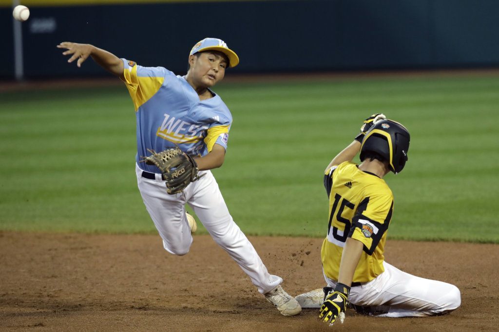 Wailuku, Hawaii, shortstop Bransyn Hong throws to first after forcing out South Riding, Va.'s Brady Yates (15) at second base during the first inning of a baseball game at the Little League World Series in South Williamsport, Pa., Wednesday, Aug. 21, 2019.