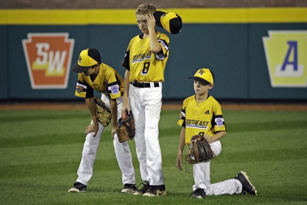 South Riding, Va.'s Liam Thyen (8) stands in the outfield after being removed from the pitching mound, with Joe Ross, left, and Noah Culpepper during the third inning of a baseball game against Wailuku, Hawaii, at the Little League World Series in South Williamsport, Pa., Wednesday, Aug. 21, 2019.