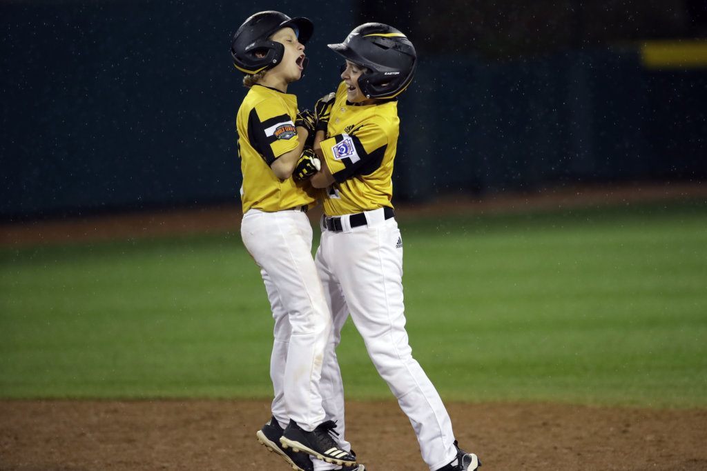 South Riding, Virginia's Noah Culpepper, left, celebrates with Kian Henson after Henson's double against Wailuku, Hawaii during the third inning of a baseball game at the Little League World Series tournament in South Williamsport, Pa., Wednesday, Aug. 21, 2019.