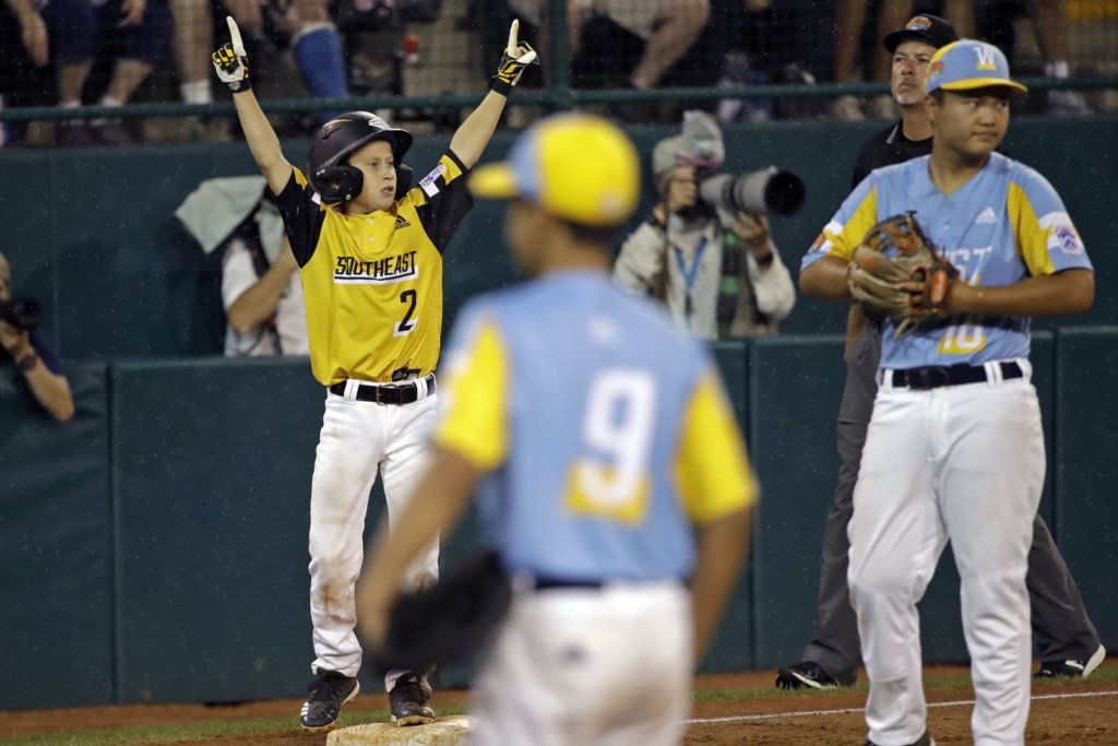 South Riding, Virginia's Noah Culpepper (2) stands on third base and celebrates his teammates Kian Henson double against Wailuku, Hawaii during the third inning of a baseball game at the Little League World Series tournament in South Williamsport, Pa., Wednesday, Aug. 21, 2019.