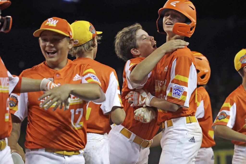 River Ridge, Louisiana pitcher Marshall Louque, right, celebrates with Egan Prather, center, after a 10-0 win over South Riding, Virginia in an elimination baseball game at the Little League World Series tournament in South Williamsport, Pa., Thursday, Aug. 22, 2019. Louque pitched a no-hitter in the win.