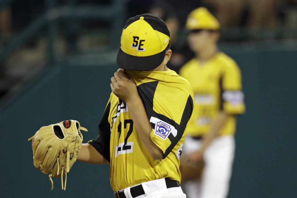 South Riding, Va.,m pitcher Justin Lee (22) wipes his face after giving up a grand slam to River Ridge, La.'s Reece Roussel during the fourth inning of a baseball game at the Little League World Series in South Williamsport, Pa., Thursday, Aug. 22, 2019.