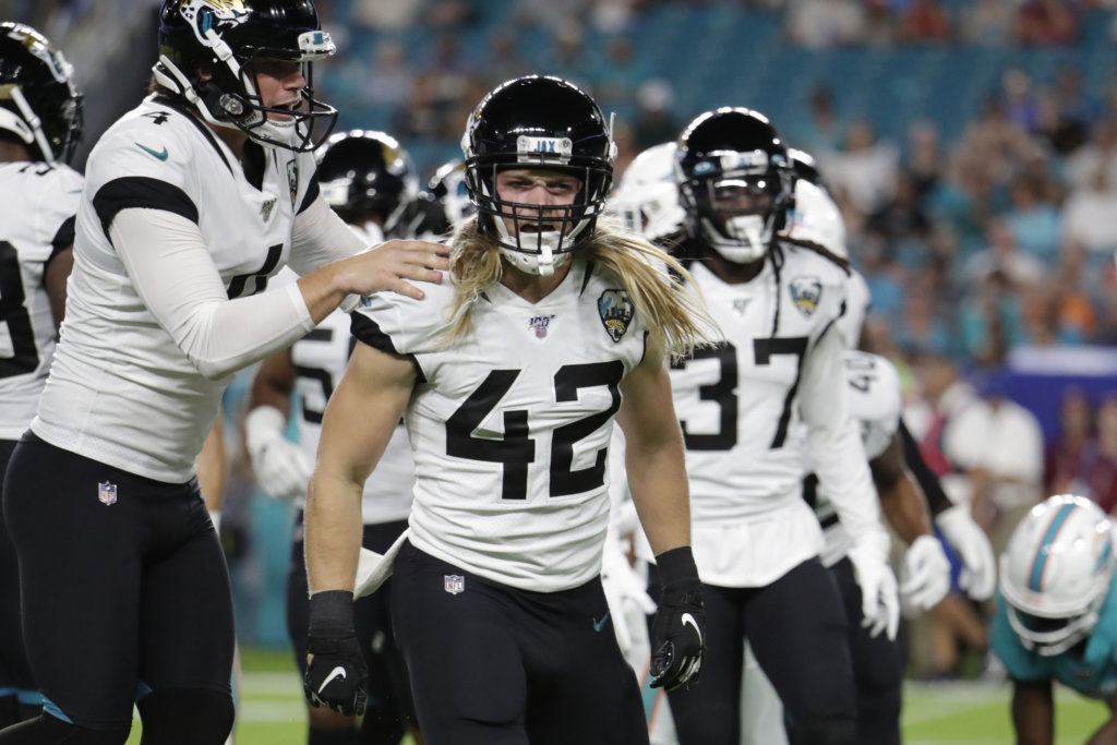 Jacksonville Jaguars kicker Josh Lambo (4) celebrates a tackle by safety Andrew Wingard (42) during the first half of an NFL football preseason game against the Miami Dolphins, Thursday, Aug. 22, 2019 in Miami Gardens, Fla.