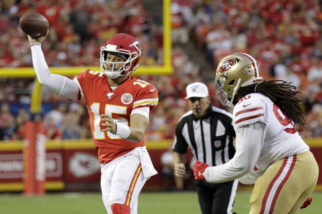 Kansas City Chiefs quarterback Patrick Mahomes (15) throws as San Francisco 49ers defensive tackle Sheldon Day (96) closes in during the first half of an NFL preseason football game in Kansas City, Mo., Saturday, Aug. 24, 2019.