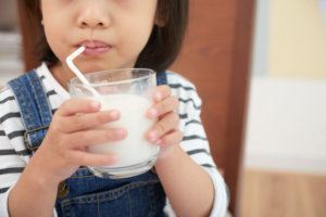 Crop girl with glass of milk