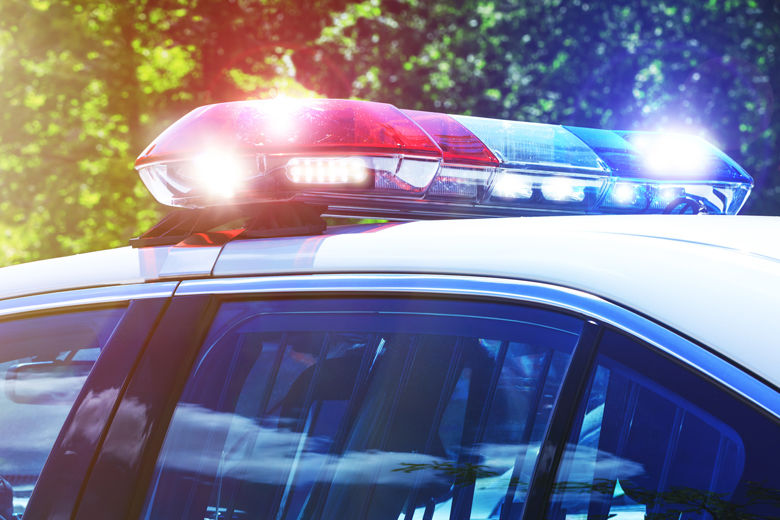 Police car with focus on siren lights. Beautiful siren lights activated in full mission activity. Policemen with patrol car in intervention operation at crime place. Emergency lights flashing on patrol car.