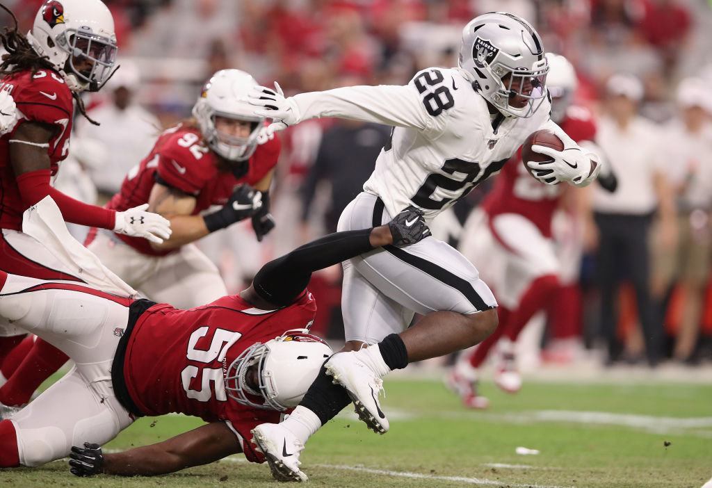 GLENDALE, ARIZONA - AUGUST 15: Running back Josh Jacobs #28 of the Oakland Raiders rushes the football during the first half of the NFL preseason game against the Arizona Cardinals at State Farm Stadium on August 15, 2019 in Glendale, Arizona.