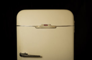 Very old fridge on a black background