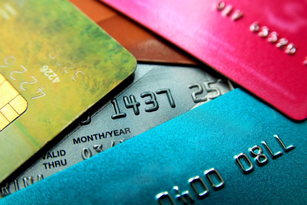 Stack of multicolored credit cards close up view with selective focus.