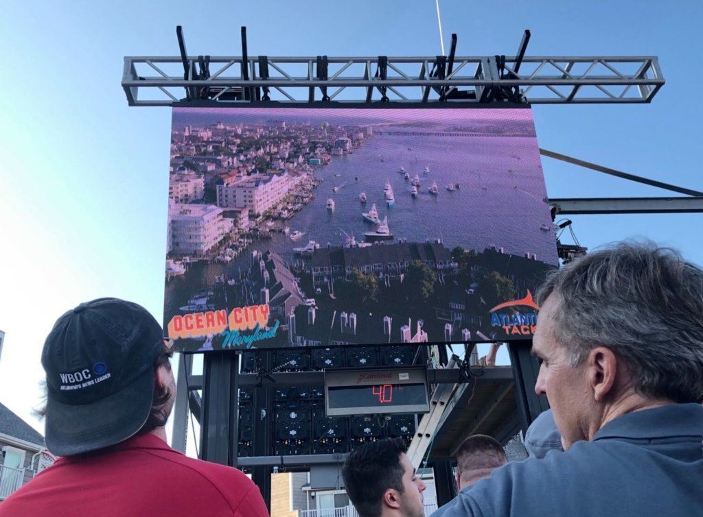 A big screen at the weigh-in dock depicts images captured by a drone.