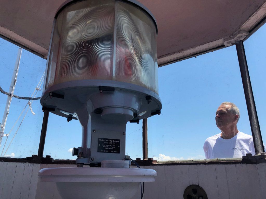 <p style="text-align: center;">John Potvin of the U.S. Lighthouse Society looks at the lighthouse light.</p>