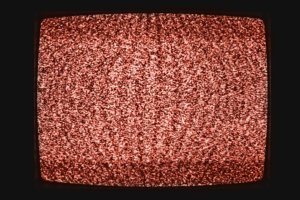 No signal analog TV screen background texture Living Coral color. Color of the Year 2019.