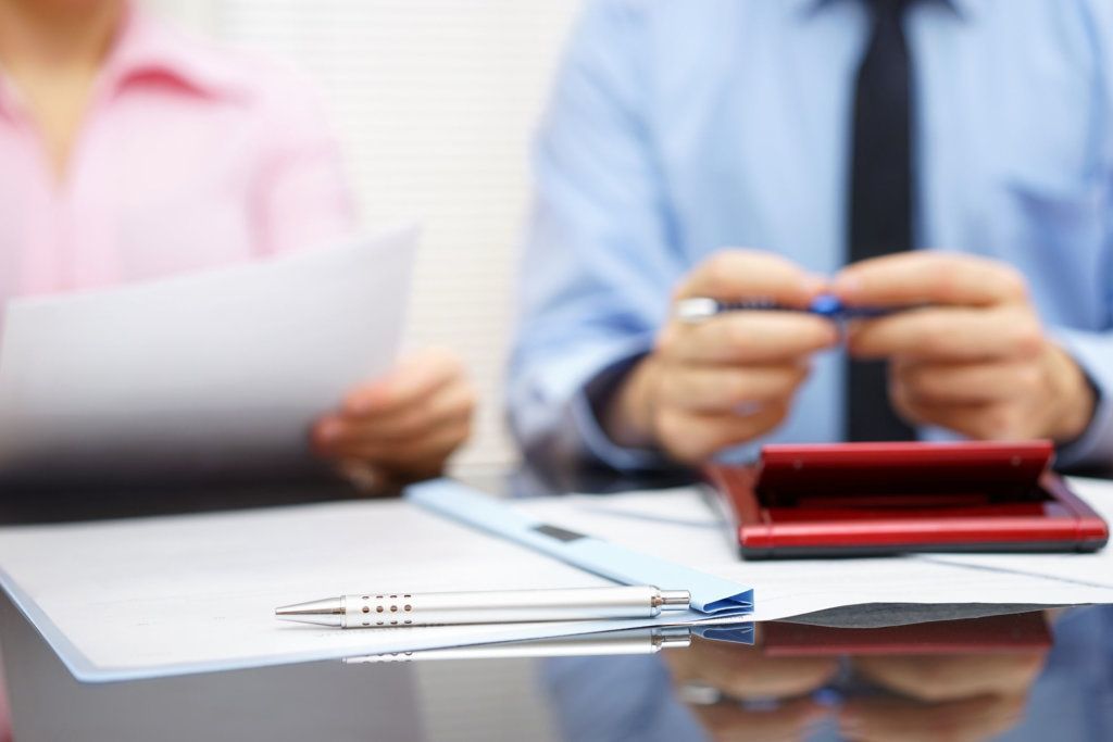Businesswoman is reading contract to businessman in blur background