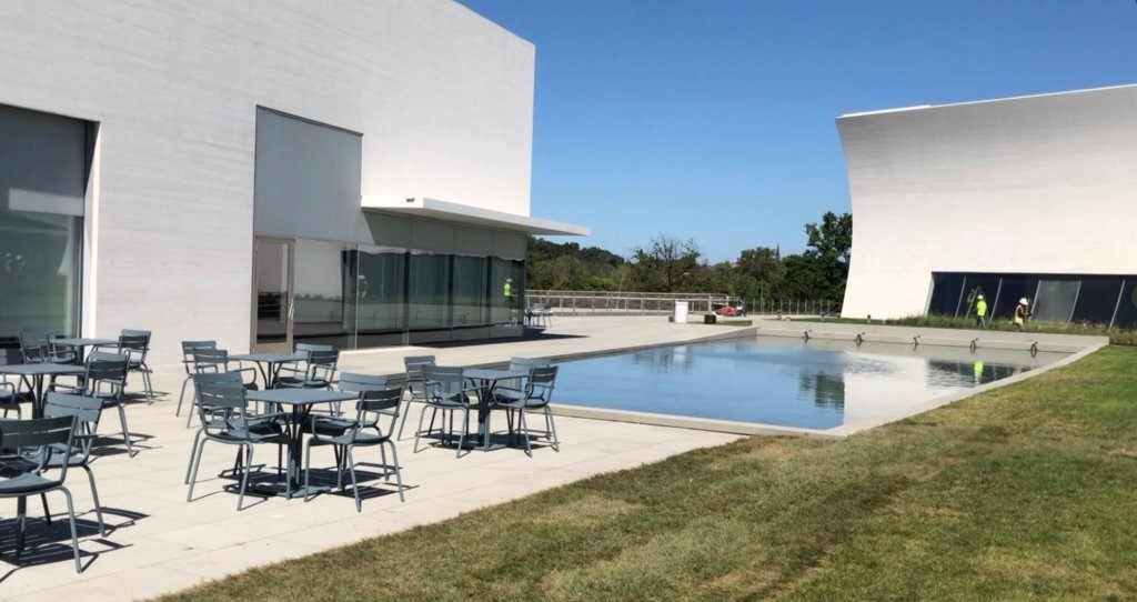 The glass walls of the River Pavilion can be pushed open to create a performance area with lawn audience seating.