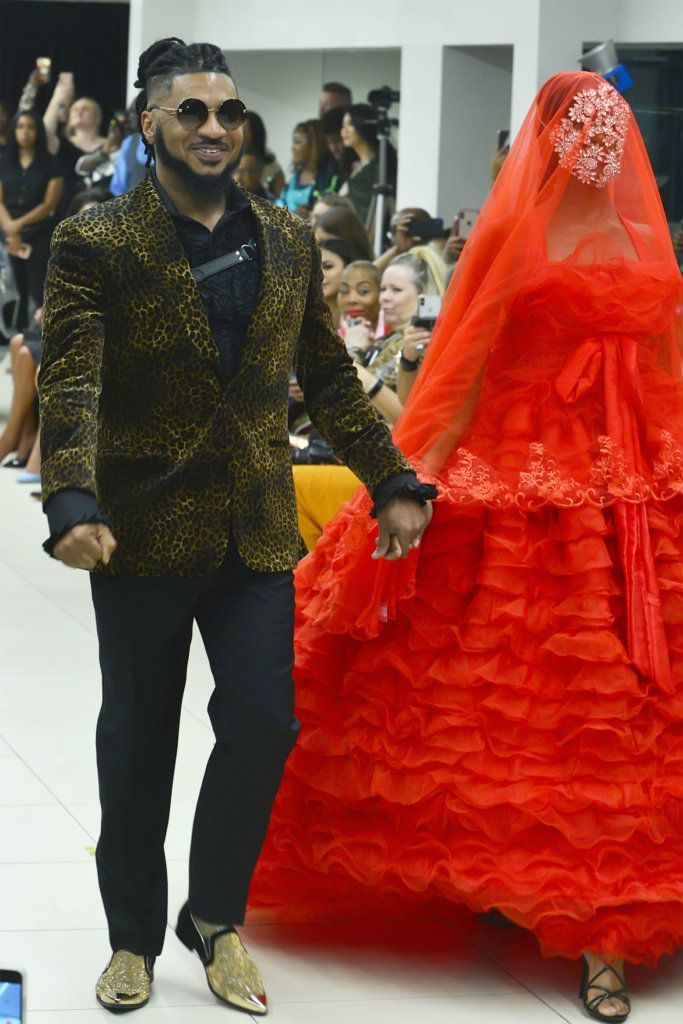 Designer Ean Williams with one of his models on the runway.