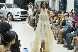 A model walks the runway at D.C. Fashion Week's opening night show.