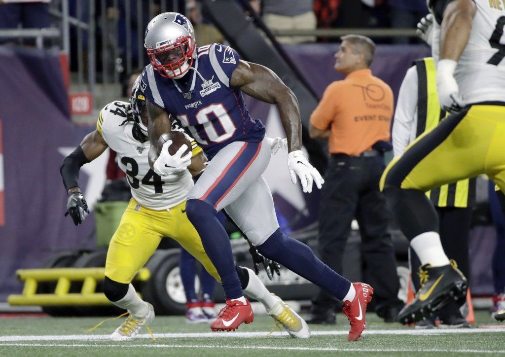 New England Patriots wide receiver Josh Gordon (10) runs for the goal line and a touchdown after catching a pass from Tom Brady in the first half of an NFL football game against the Pittsburgh Steelers, Sunday, Sept. 8, 2019, in Foxborough, Mass.