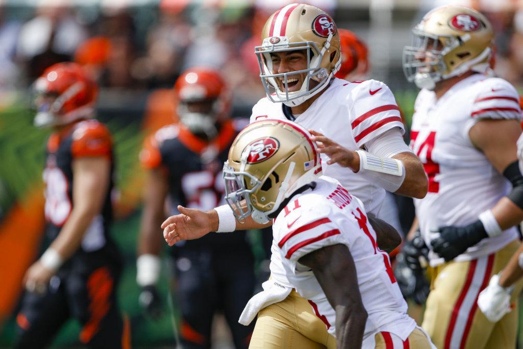 San Francisco 49ers quarterback Jimmy Garoppolo, above, celebrates after wide receiver Marquise Goodwin, below, scores a touchdown during the first half an NFL football game against the Cincinnati Bengals, Sunday, Sept. 15, 2019, in Cincinnati.