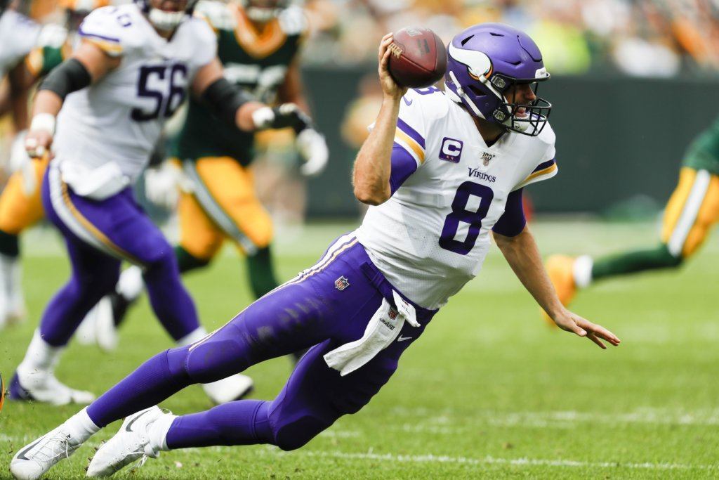 Minnesota Vikings' Kirk Cousins throws as he falls during the second half of an NFL football game against the Green Bay Packers Sunday, Sept. 15, 2019, in Green Bay, Wis.