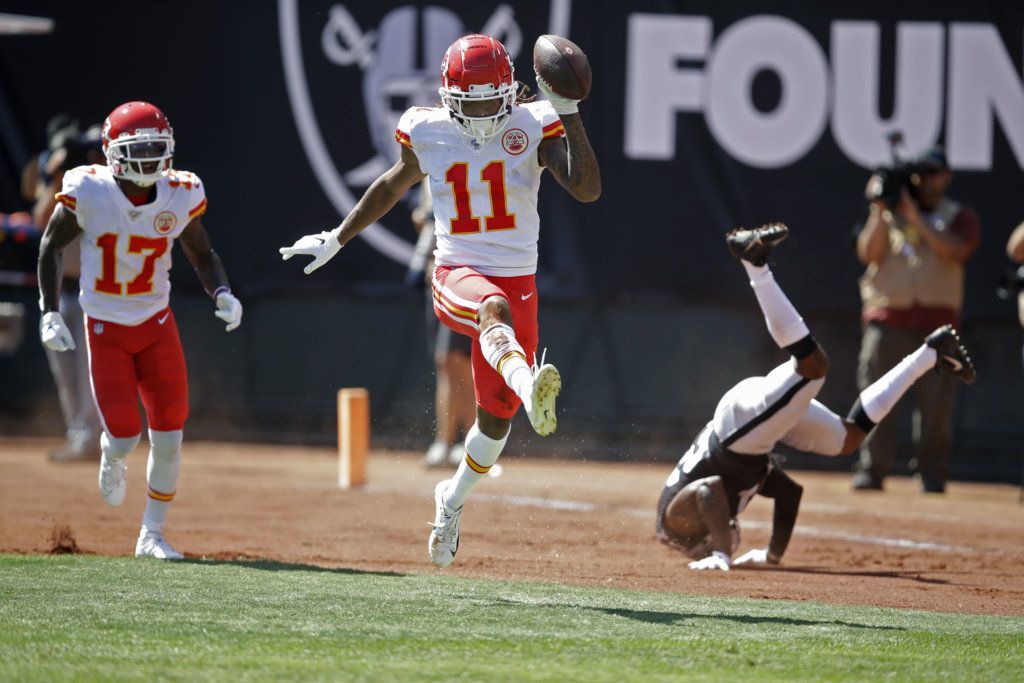 Kansas City Chiefs wide receiver Demarcus Robinson (11) celebrates after scoring a touchdown as teammate Mecole Hardman (17) looks on during the first half of an NFL football game against the Oakland Raiders Sunday, Sept. 15, 2019, in Oakland, Calif. At right is Oakland Raiders cornerback Gareon Conley.
