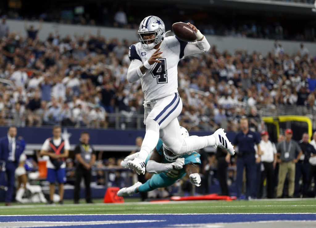 Dallas Cowboys quarterback Dak Prescott (4) gets past Miami Dolphins defensive back Walt Aikens (35) and into the end zone for a touchdown in the second half of an NFL football game in Arlington, Texas, Sunday, Sept. 22, 2019.