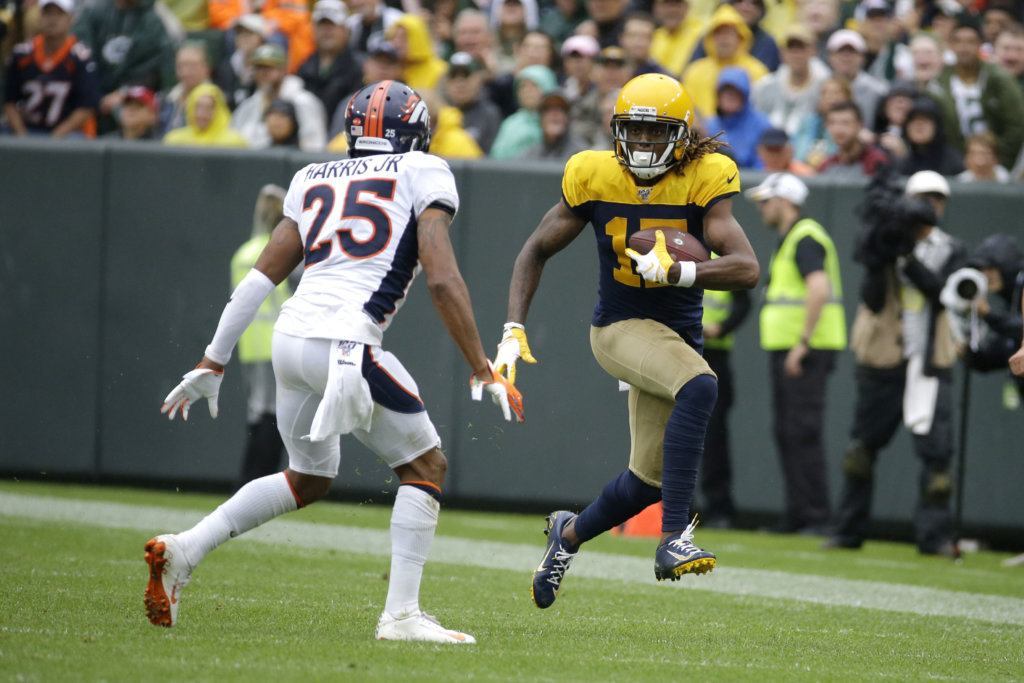 Green Bay Packers wide receiver Davante Adams, right, runs with the ball after catching a pass as Denver Broncos cornerback Chris Harris (25) defends during the second half of an NFL football game Sunday, Sept. 22, 2019, in Green Bay, Wis.