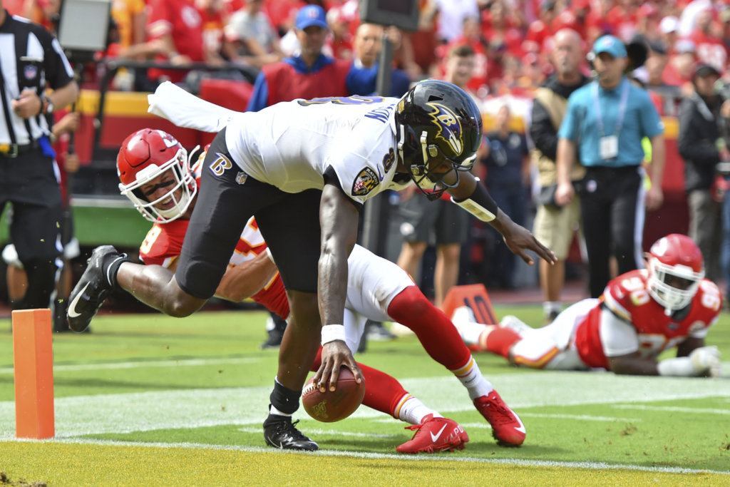 Baltimore Ravens quarterback Lamar Jackson (8) scores a touchdown in front of Kansas City Chiefs safety Daniel Sorensen (49) during the second half of an NFL football game in Kansas City, Mo., Sunday, Sept. 22, 2019.