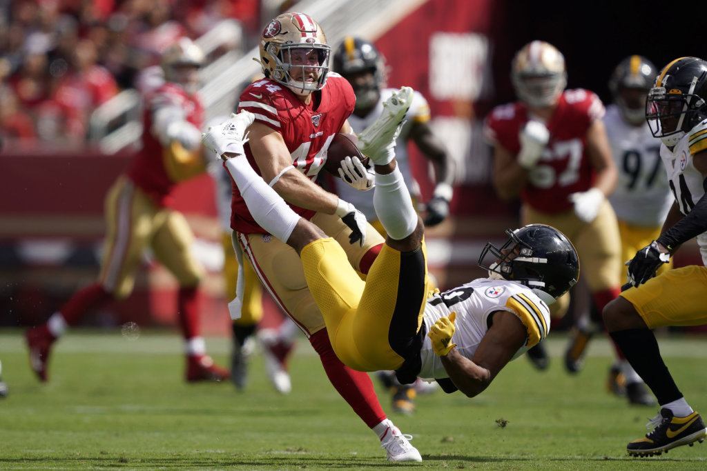 San Francisco 49ers fullback Kyle Juszczyk, left, breaks a tackle attempt by Pittsburgh Steelers free safety Minkah Fitzpatrick during the first half of an NFL football game in Santa Clara, Calif., Sunday, Sept. 22, 2019.