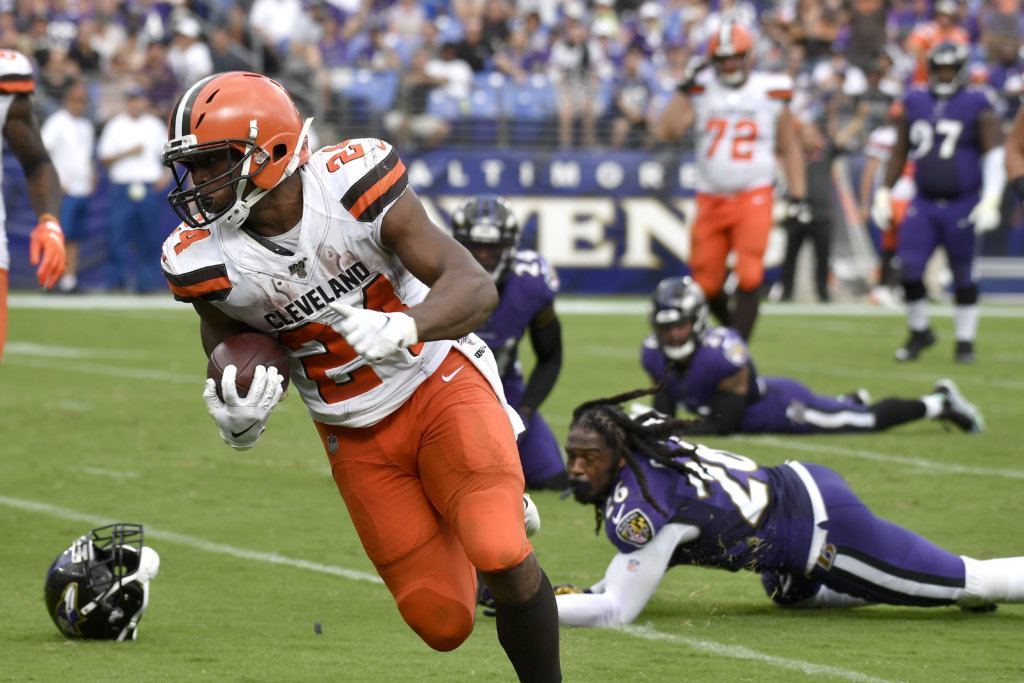 Cleveland Browns running back Nick Chubb (24) prepares to cross the goal line after avoiding several tackles from Baltimore Ravens defenders during the second half of an NFL football game Sunday, Sept. 29, 2019, in Baltimore.