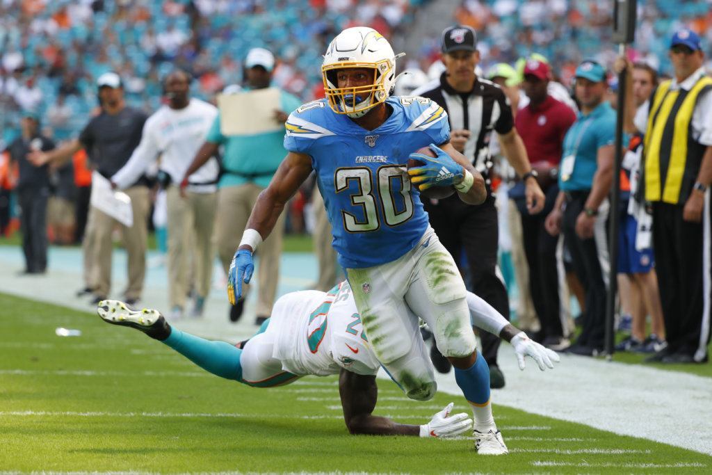 Miami Dolphins free safety Reshad Jones (20) misses a tackles as Los Angeles Chargers running back Austin Ekeler (30) runs for a touchdown, during the first half at an NFL football game against the Miami Dolphins, Sunday, Sept. 29, 2019, in Miami Gardens, Fla.