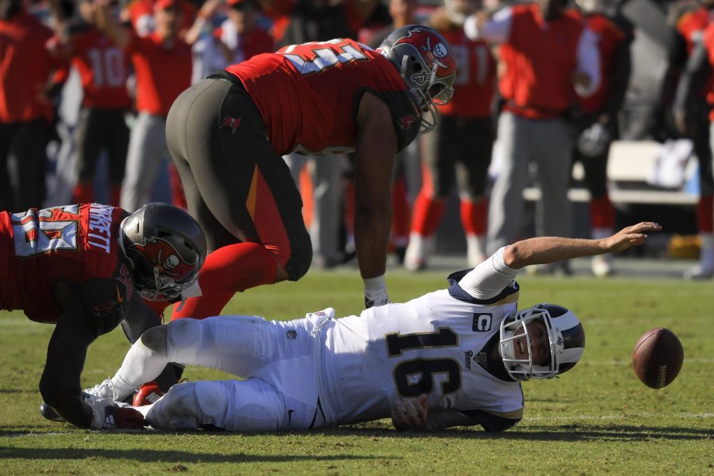 Tampa Bay Buccaneers linebacker Shaquil Barrett, left, forces a fumble by Los Angeles Rams quarterback Jared Goff during the second half of an NFL football game Sunday, Sept. 29, 2019, in Los Angeles. The fumble was returned by a touchdown by nose tackle Ndamukong Suh, top.