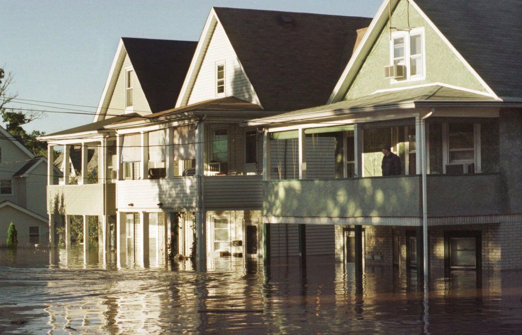 A man surveys his flooded neighborhood in Bound Brook, N.J., from his second floor porch in this Sept. 17, 1999 photo. The remnants of Hurricane Floyd that flooded New Jersey last Sept., killed four people, caused more than $500 million in damage and ruined thousands of homes and businesses.