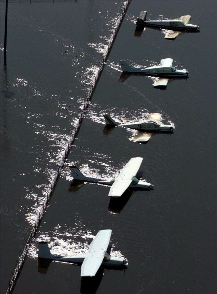 Floodwaters from the Tar River rush past parked planes at the airport in Greenville, N.C., Saturday, Sept. 18, 1999. The Tar River has yet to crest in Greenville from the effects of Hurricane Floyd which passed through the area Thursday.