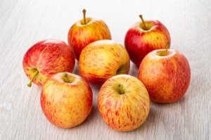 Few of striped apples on wooden table