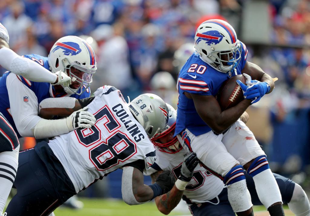 ORCHARD PARK, NY — SEPTEMBER 29: Jamie Collins #58 of the New England Patriots tries to make a tackle on Frank Gore #20 of the Buffalo Bills during the second half at New Era Field on September 29, 2019 in Orchard Park, New York. Patriots beat the Bills 16-10.