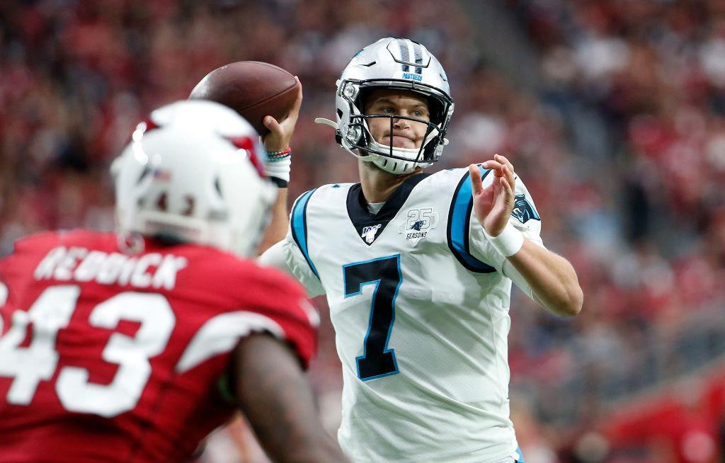 GLENDALE, ARIZONA — SEPTEMBER 22: Quarterback Kyle Allen #7 of the Carolina Panthers throws a touchdown pass to Greg Olsen #88 of the Panthers (not pictured) during the first half of the NFL football game against the Arizona Cardinals at State Farm Stadium on September 22, 2019 in Glendale, Arizona.
