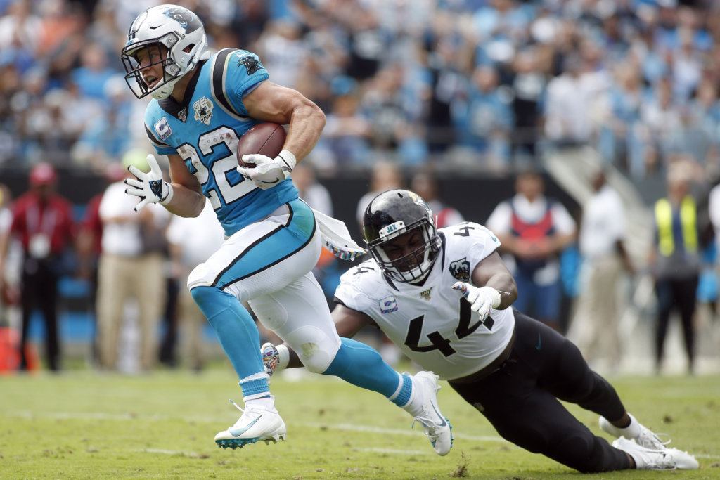 Carolina Panthers running back Christian McCaffrey (22) runs for a tuchdown as Jacksonville Jaguars middle linebacker Myles Jack (44) reaches during the first half of an NFL football game in Charlotte, N.C., Sunday, Oct. 6, 2019.