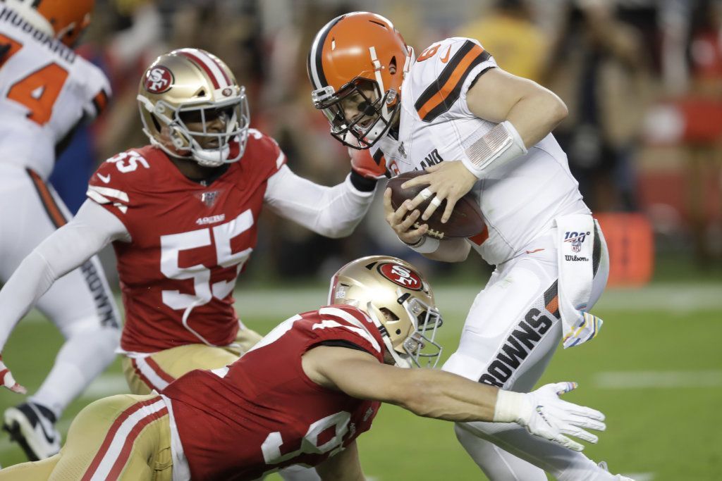 Cleveland Browns quarterback Baker Mayfield, top right, is sacked by San Francisco 49ers defensive end Nick Bosa, bottom, during the first half of an NFL football game in Santa Clara, Calif., Monday, Oct. 7, 2019. Also pictured is 49ers defensive end Dee Ford (55).